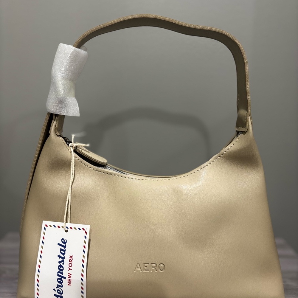 Cream Shoulder Bag with Minimalist Design and Curved Handle